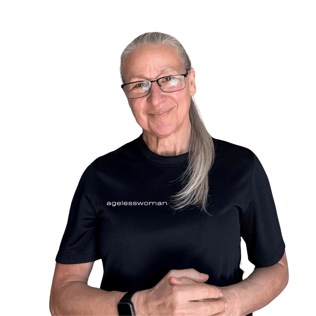 Person with long gray hair wearing a black shirt with 'agelesswoman' printed on it.